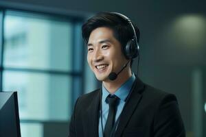 Portrait of a Handsome Asian Man, Customer Service Operator, Call Center Worker Talking Through Headset with Customer in Modern Office. photo