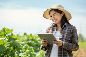 Portrait of Female Farmer Using Tablet in the Farm, Observes and Check Growth Plants, Agriculture Smart Farming Concept photo
