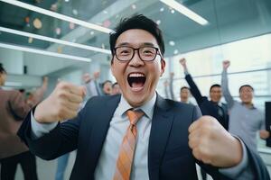 Happy Successful Asian Businessman Celebrating in Modern Office, Celebrate Success and Achieving Goals, Male Entrepreneur Celebrate Winning Moments. photo