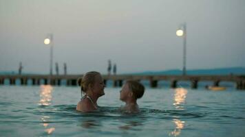 Mother helping son to jump in water video