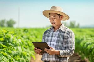 Portrait of Male Farmer Using Tablet in the Farm, Observes and Check Growth Plants, Agriculture Smart Farming Concept photo