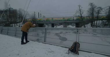 Man making mobile video of passing train