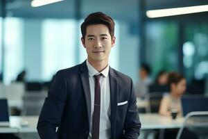 Portrait of a Handsome Businessman in Modern Office, Asian Manager Looking at Camera and Smiling, Confident Male CEO Planning and Managing Company Strategy. photo