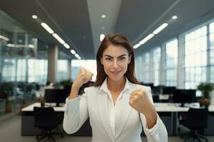 Confident Businesswoman Showing a Fighting Pose, Beautiful Manager Gestures Raising Fists in Modern Office, Female Entrepreneur Fights a Problem photo