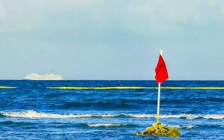 Red flag swimming prohibited high waves Playa del Carmen Mexico. photo