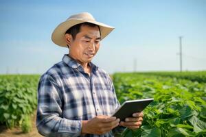 Portrait of Male Farmer Using Tablet in the Farm, Observes and Check Growth Plants, Agriculture Smart Farming Concept photo