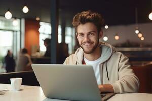 Portrait of Cheerful Male Student Learning Online in Coffee Shop, Young European Man Studies with Laptop in Cafe, Doing Homework photo