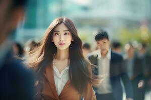 Beautiful Businesswoman Walking in Modern City, Asian Woman Walks on a Crowded Pedestrian Street, Business Manager Surrounded by Blur People on Busy Street. photo