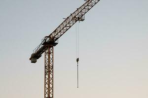 Tower crane. Construction site. Building industry. Tall and heavy machine. Industrial usage. photo