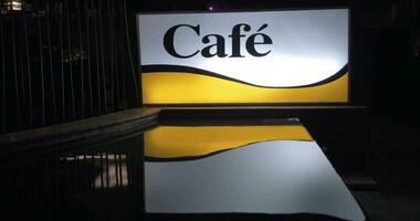 Illuminated cafe banner at night video