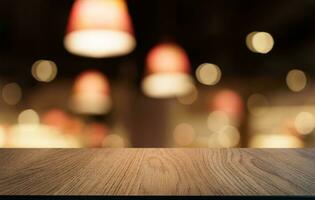 Mock up for space. Empty dark wooden table in front of abstract blurred bokeh background of restaurant . can be used for display or montage your product photo