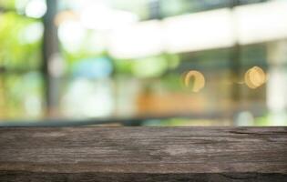 Mock up for space. Empty dark wooden table in front of abstract blurred bokeh background of restaurant . can be used for display or montage your product photo