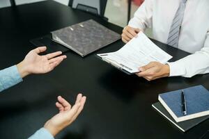 Examiner reading a resume during job interview at office Business and human resources concept. photo