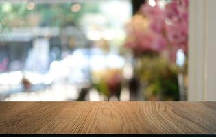 Empty wooden table in front of abstract blurred background of coffee shop . can be used for display or montage your products.Mock up for display of product photo