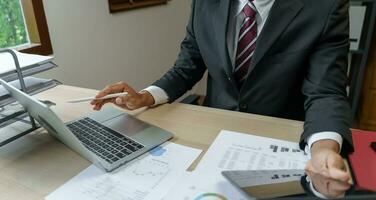 Business man working with laptop. Young business man thinking Concentrated at work. photo