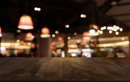 Mock up for space. Empty dark wooden table in front of abstract blurred bokeh background of restaurant . can be used for display or montage your product photo