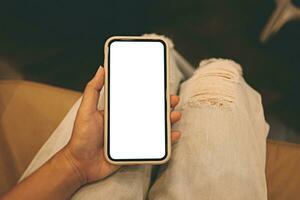 Women's hands holding cell telephone blank copy space screen. smartphone with blank white screen isolated on white background . smart phone with technology concept photo