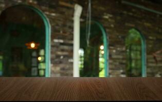 Empty wooden table in front of abstract blurred background of coffee shop . can be used for display or montage your products.Mock up for display of product photo