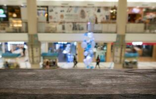 Empty wooden table in front of abstract blurred background of coffee shop . can be used for display or montage your products.Mock up for display of product photo