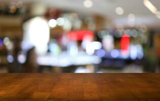 Empty wooden table in front of abstract blurred background of coffee shop . can be used for display or montage your products.Mock up for display of product photo