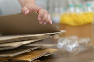 Home recycle eco zero waste concept Man using recycle paper box. Stacking brown cardboard box eco friendly packaging made of recyclable raw materials. photo