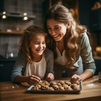 Mother and daughter baking cookies together photo