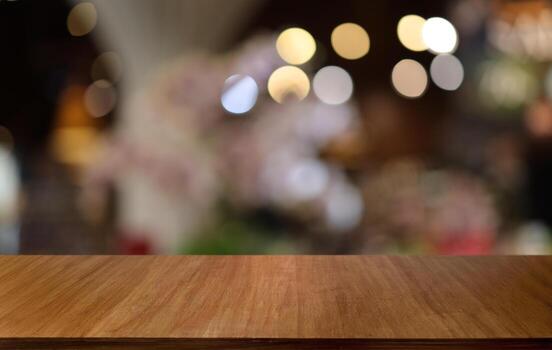 Empty wooden table in front of abstract blurred background of coffee shop . can be used for display or montage your products.Mock up for display of product photo