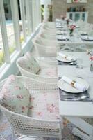 The wedding decor. Tables set for an event party or wedding reception. luxury elegant table setting dinner in a restaurant. glasses and dishes. hall for banquets and weddings. photo