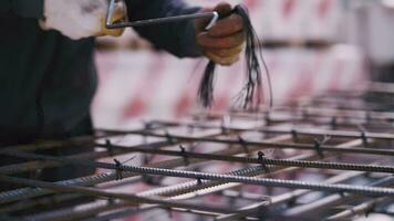 worker fastens the reinforcement with metal wire video