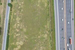 High Angle View of British Motorways and Highways and Traffic on M1 Junction 11a of Luton and Dunstable England UK. Image Was Captured on August 15th, 2023 photo