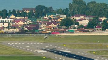 Unrecognizable helicopter takeoff and climb, rear view, long shot video