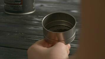 Woman filling the funnel of moka pot with ground coffee video