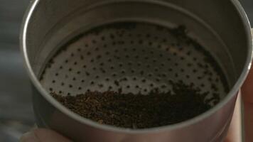Filling in funnel with ground coffee for moka pot video