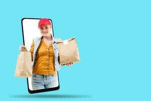 Woman giving food order isolated on color background. Female courier holding paper packet with food. Products delivery from shop or restaurant to home. Copy space photo