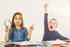 Portrait of smart schoolkids standing in line and looking at camera photo