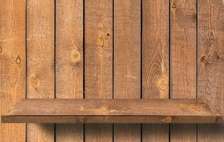 Empty wood shelf on wooden wall photo