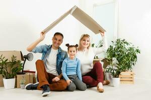 Family unpacking cardboard boxes at new home photo