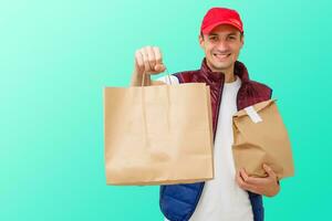 Delivery man in mask and gloves bring fresh food to customer's home. Stay home. Online shopping concept. blue background photo