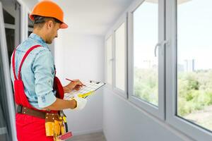 Worker with a diy tool belt over construction background photo