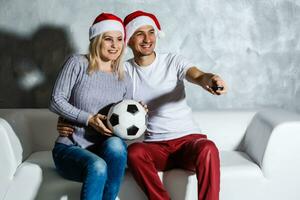 Fascinated man and woman watching football match photo