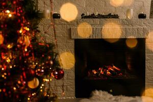 Christmas tree near fireplace in room photo