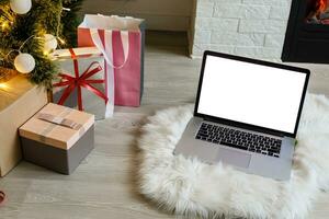 laptop with gift box and christmas lights background photo
