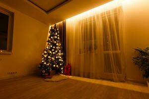 Illuminated Christmas tree decorated in modern living room photo