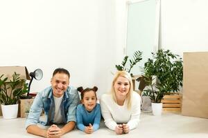 Cheerful couple and their daughter staying at home photo