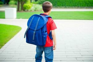 Back view of a schoolboy with a backpack standing in the classroom.  AI Generative Pro Photo