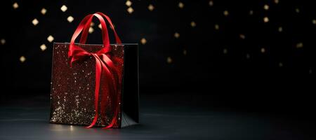 A red shopping bag on a black background. Shopping, Black Friday, Discounts photo