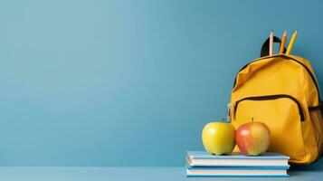 Backpack with different school stationery on light blue background photo