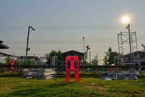 Red plastic chair with an empty stage after the concert photo