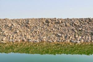 Pile of soil, Mound and water photo