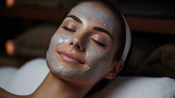 Woman receiving facial mask treatment photo